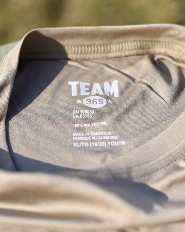 BSBL ONLY. T-shirt showing "Team 365, 100% polyester, made in Cambodia"