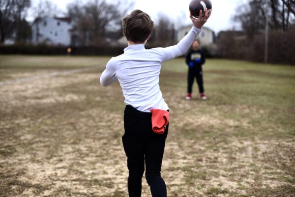SpeedyPetey throwing the football with the microfiber performance sports towel in his waistband