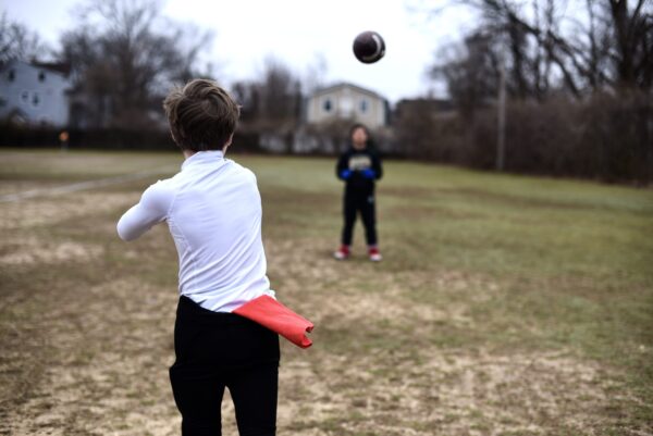 SpeedyPetey throwing the football with the microfiber performance sports towel in his waistband