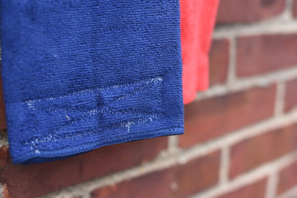 Blue and Red Performance Sports Towel showing closeup of reinforced stitching