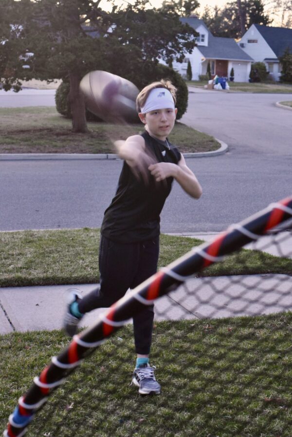 SpeedyPetey throwing the football while wearing the SPEEDY performance sports headband in white and SPEEDY sleeveless tee-shirt in black