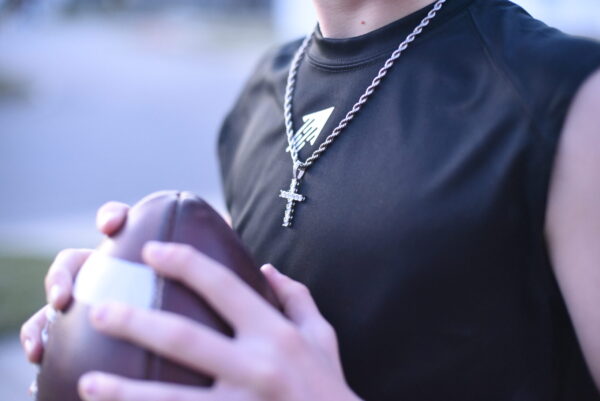 The SPEEDY Sleeveless Performance Tee in black with the white icon on the front