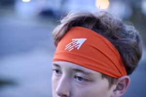 Speedy performance sports headband in orange with white icon