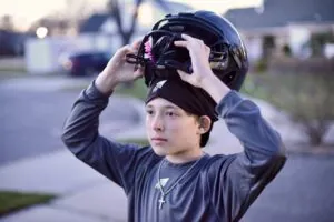 SpeedyPetey with the SPEEDY Performance Sport Beanie as he puts on his football helmet