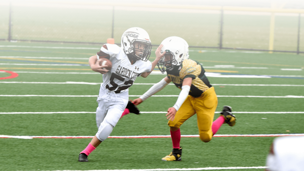 SpeedyPetey52 stiff-arms a defender while running the football