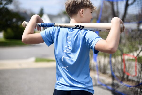 BSBL Only. t-shirt in blue. Rear posing with bat